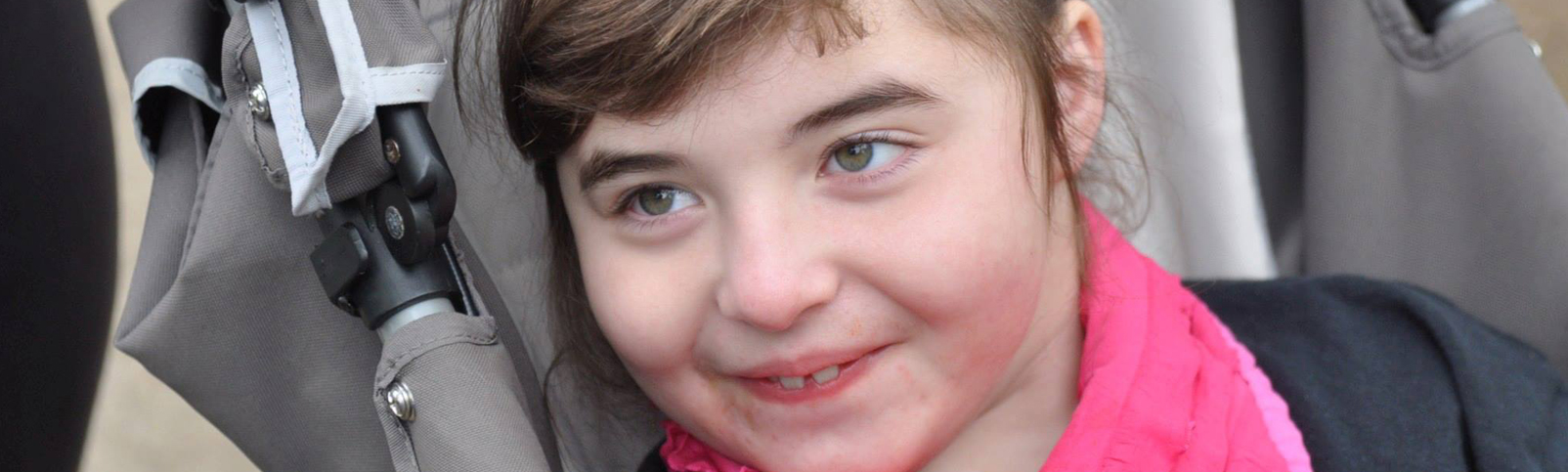 Image of girl with Angelman syndrome smiling