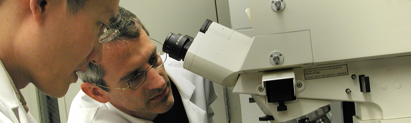 Researchers in a lab looking at a sample to put under amicroscope