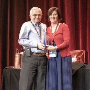 Amanda Moore presenting Art Beaudet, MD with an award