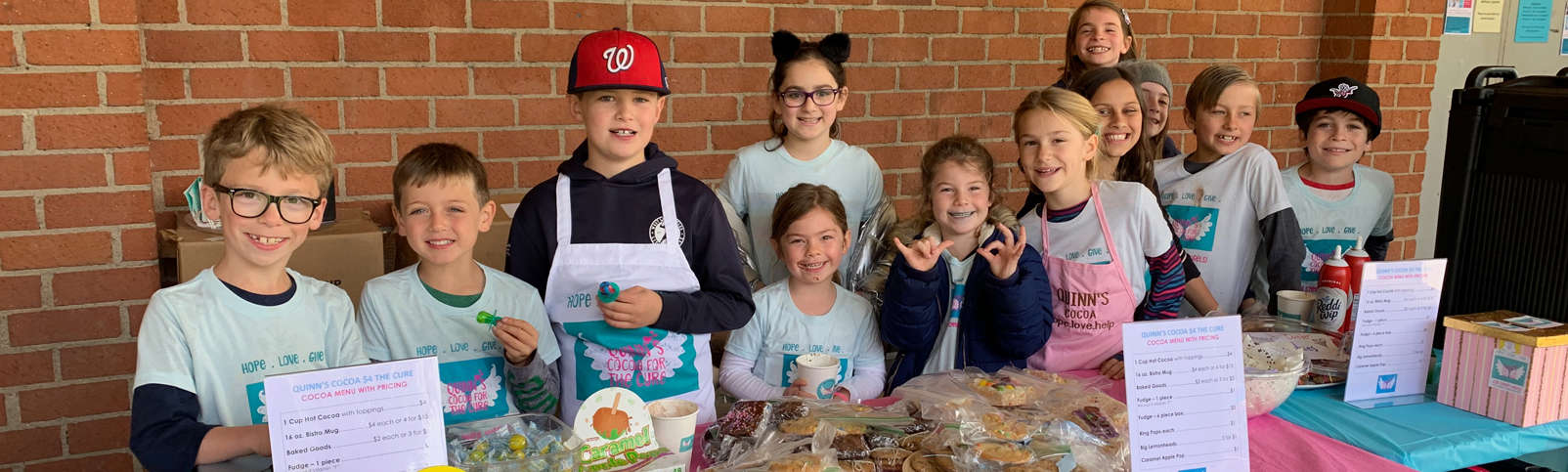 Quinn's cocoa for the cure. Quinn and friends selling treats and cocoa.