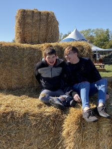 Brothers, Evin and Mathew Perry sitting on hay bales