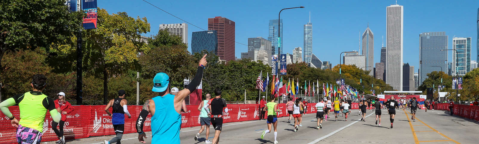 runners running toward the finish line and Chicago buildings